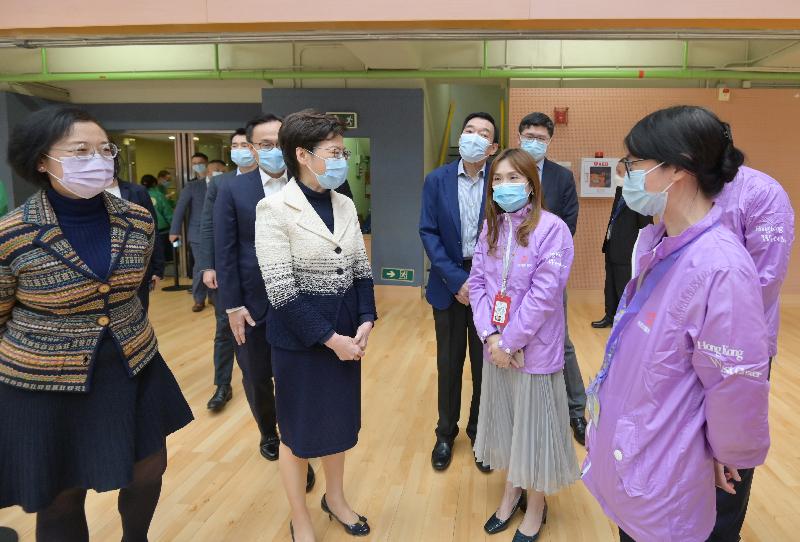 The Chief Executive, Mrs Carrie Lam, today (March 10) visited the Community Vaccination Centre at Sun Yat Sen Memorial Park Sports Centre. Photo shows Mrs Lam (third left) chatting with the healthcare workers of the centre. Looking on are the Secretary for the Civil Service, Mr Patrick Nip (second left); the Secretary for Food and Health, Professor Sophia Chan (first left); and the Chairman of the Hospital Authority, Mr Henry Fan (fourth left).