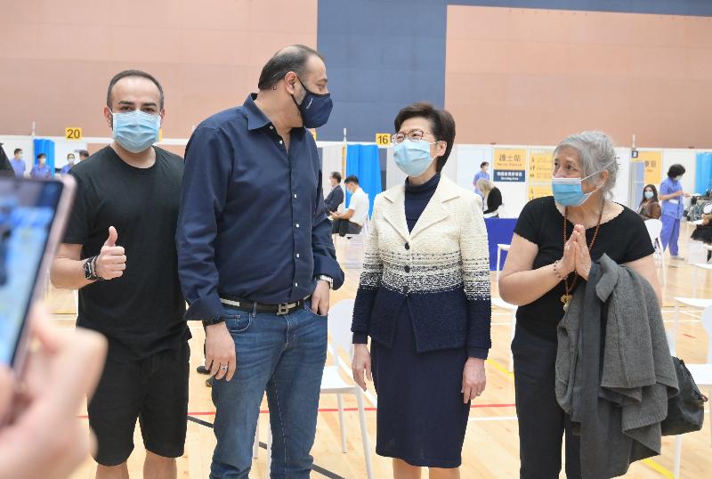 The Chief Executive, Mrs Carrie Lam, today (March 10) visited the Community Vaccination Centre at Sun Yat Sen Memorial Park Sports Centre. Photo shows Mrs Lam (second right) chatting with members of the public who received vaccination at the centre. 