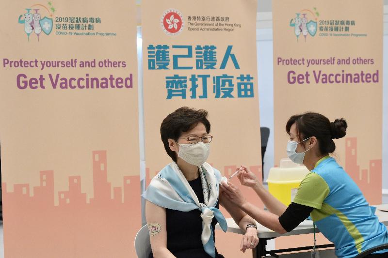 The Chief Executive, Mrs Carrie Lam, together with a number of Secretaries of Departments and Directors of Bureaux, received the second COVID-19 vaccination dose at the Conference Hall, Central Government Offices, Tamar, this morning (March 22). Photo shows Mrs Lam (left) receiving the vaccine.