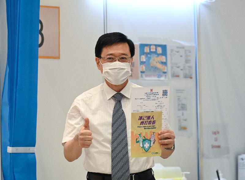 The Chief Executive, Mrs Carrie Lam, together with a number of Secretaries of Departments and Directors of Bureaux, received the second COVID-19 vaccination dose at the Conference Hall, Central Government Offices, Tamar, this morning (March 22). Photo shows the Secretary for Security, Mr John Lee, with his vaccination record.