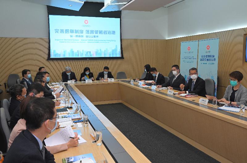The Financial Secretary, Mr Paul Chan, today (March 31) met with representatives from the business sector to explain the amendments to Annex I to the Basic Law on Method for the Selection of the Chief Executive of the Hong Kong Special Administrative Region (HKSAR) and Annex II to the Basic Law on Method for the Formation of the Legislative Council of the Hong Kong Special Administrative Region and its Voting Procedures approved by the Standing Committee of the National People's Congress in regard to the National People's Congress’s decision on improving the electoral system of the HKSAR. Photo shows Mr Chan (second right) meeting with representatives of the Hong Kong Chinese Enterprises Association. Also present is the Under Secretary for Commerce and Economic Development, Dr Bernard Chan (third right).