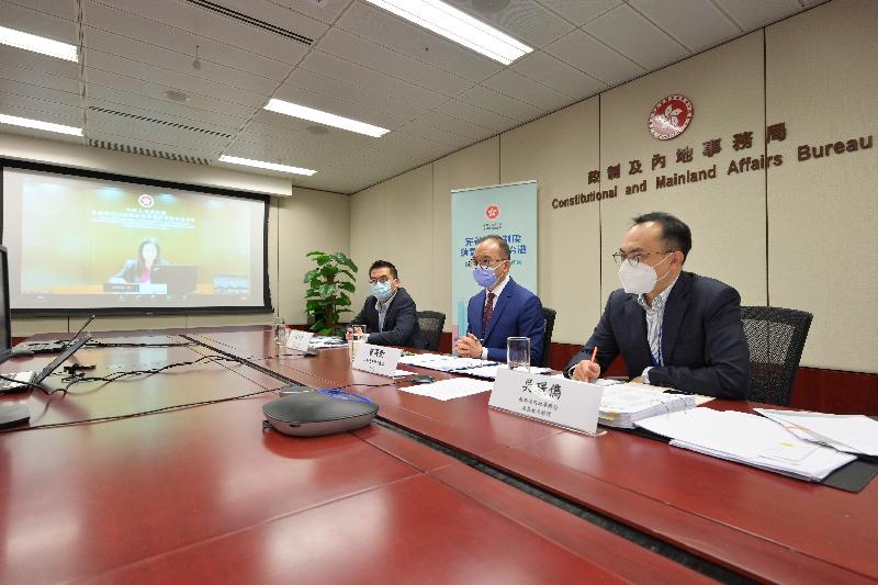 The Secretary for Constitutional and Mainland Affairs, Mr Erick Tsang Kwok-wai, today (April 2) chaired five briefing sessions by video conferencing to introduce the background, concepts and main contents of improving the electoral system of the HKSAR for representatives of associations formed by Hong Kong residents in the Mainland and Hong Kong residents living in the Mainland via Mainland offices of the HKSAR Government in Beijing, Guangdong, Shanghai, Chengdu and Wuhan. Photo shows Mr Tsang (second right) exchanging views on the improvements to the HKSAR's electoral system with the Acting Director of the Hong Kong Economic and Trade Office in Guangdong, Ms Anne Pak (on the screen) and Hong Kong residents living in the Mainland.