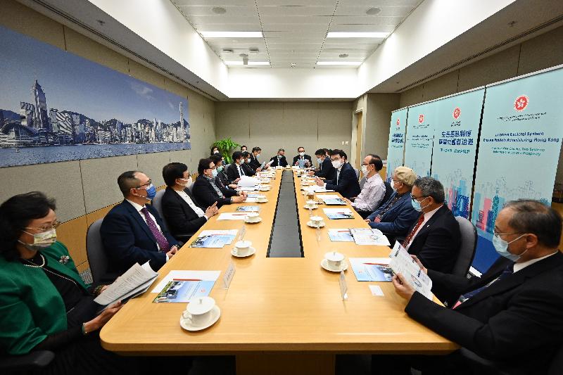 The Secretary for Commerce and Economic Development, Mr Edward Yau (fifth right), briefs representatives from the publishing sector on the improvements to the electoral system of Hong Kong today (April 12).