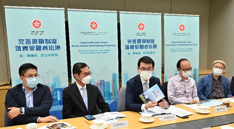 The Secretary for Commerce and Economic Development, Mr Edward Yau (centre), briefs representatives from the publishing sector on the improvements to the electoral system of Hong Kong today (April 12).