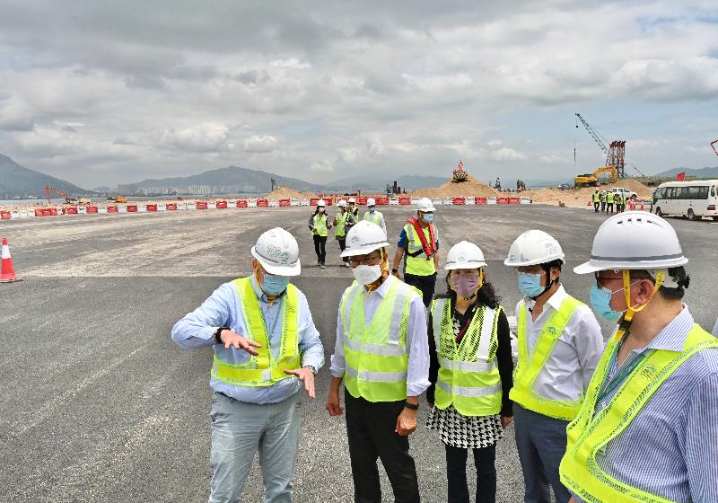 The Financial Secretary, Mr Paul Chan, visited Hong Kong International Airport (HKIA) and the construction site of HKIA's three-runway system (3RS) today (April 12) to learn about the progress of major projects of the Airport Authority Hong Kong (AA). Photo shows Mr Chan (second left), accompanied by the Permanent Secretary for Transport and Housing (Transport), Ms Mable Chan (centre), and the Chief Executive Officer of the AA, Mr Fred Lam (second right), being briefed on the latest progress of the 3RS construction works.
