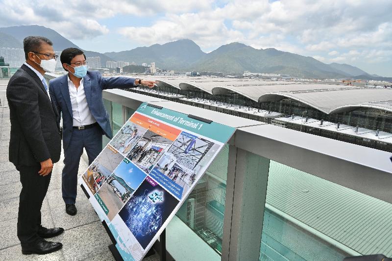 The Financial Secretary, Mr Paul Chan, visited Hong Kong International Airport (HKIA) and the construction site of HKIA's three-runway system today (April 12) to learn about the progress of major projects of the Airport Authority Hong Kong (AA). Photo shows Mr Chan (left) being briefed by the Chief Executive Officer of the AA, Mr Fred Lam (right), on the progress of various projects under the Airport City strategy.
