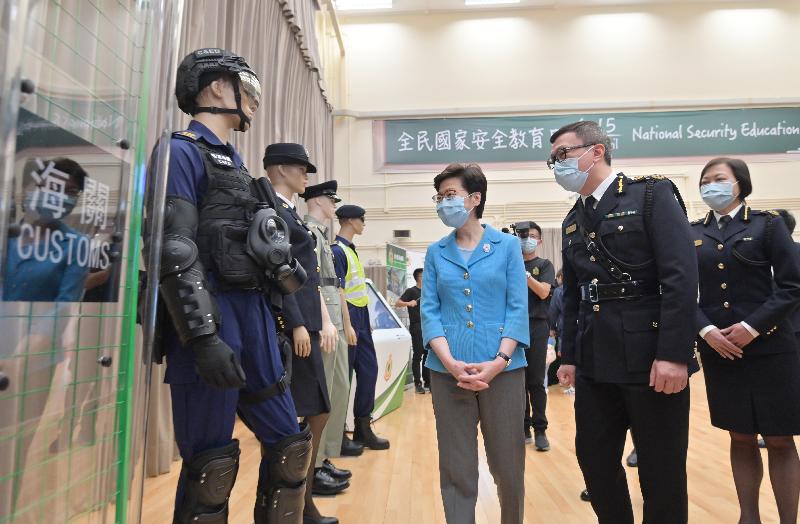 The Chief Executive, Mrs Carrie Lam, today (April 15) visited the Hong Kong Customs College in Tuen Mun, joining members of the public to participate in the open day activities at the training schools of the disciplinary forces organised in support of National Security Education Day. Photo shows Mrs Lam (left) being briefed by the Commissioner of Customs and Excise, Mr Hermes Tang (centre), on the equipment of Customs officers.