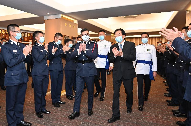 The Chairman of the Standing Committee on Disciplined Services Salaries and Conditions of Service, Dr Chui Hong-sheung (first right), and the Commissioner of Police, Mr Tang Ping-keung (second right) congratulate the probationary inspectors after a passing-out parade at the Hong Kong Police College today (April 17).