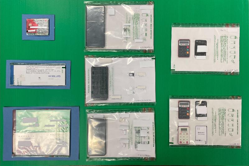 Hong Kong Customs mounted an operation codenamed "Shadow Hunter II" between April 15 and 19. A money laundering syndicate has been smashed successfully while the amount involved in the case has reached $2.5 billion. Six persons were arrested. Photo shows some of the mobile phones, banking security authentication tokens and cheque books seized by Customs officers during the operation.