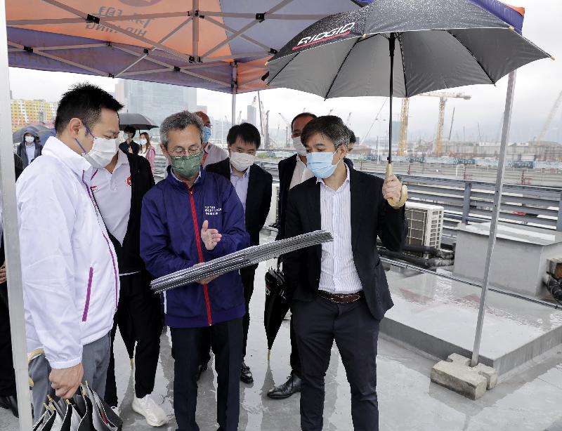 The Secretary for Home Affairs, Mr Caspar Tsui, viewed the works progress of the Kai Tak Sports Park site today (April 27). Photo shows Mr Tsui (first left) being briefed by representatives of Kai Tak Sports Park Ltd about the construction of the project.