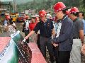 The Chief Secretary for Administration, Mr Henry Tang, led a government delegation to Sichuan and inspected on-site today (July 5) the progress of some post-quake reconstruction projects funded by Hong Kong. Photo showing Mr Tang being briefed on the re-construction progress of the Shuimo Secondary School in Wenchuan.