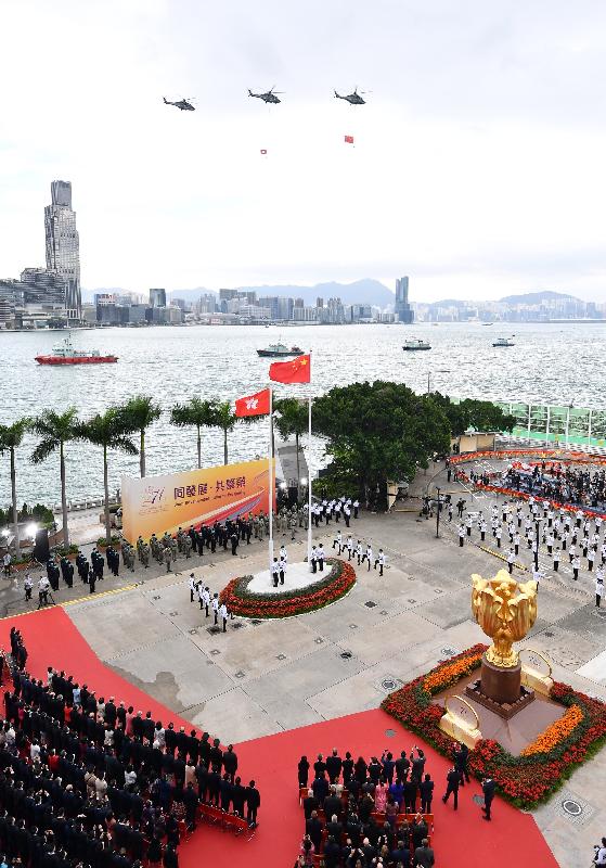 The disciplined services and the Government Flying Service perform a sea parade and a fly-past to mark the 71st anniversary of the founding of the People's Republic of China at the flag-raising ceremony at Golden Bauhinia Square in Wan Chai this morning (October 1).