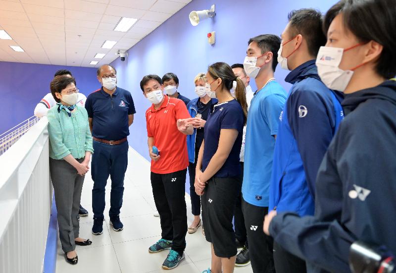 The Chief Executive, Mrs Carrie Lam, this afternoon (May 11) visited the Hong Kong Sports Institute (HKSI) to learn more about the training of the athletes in preparation for the Olympic Games to be held in Tokyo. Photo shows Mrs Lam (first left) chatting with the coach and athletes of the badminton team. Looking on is the Chairman of the Board of Directors of the HKSI, Dr Lam Tai-fai (second left).