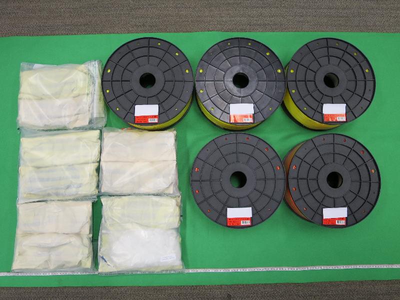 Hong Kong Customs seized about 5 kilograms of suspected methamphetamine with an estimated market value of about $3 million at the Kwai Chung Customhouse Cargo Examination Compound on May 14. Photo shows the suspected methamphetamine seized and the spools of rubber tubes used to conceal the dangerous drugs.