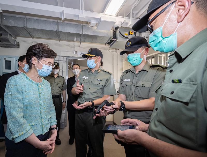 The Chief Executive, Mrs Carrie Lam, officiated at the "Smart Prison" launching ceremony at Tai Tam Gap Correctional Institution of the Correctional Services Department today (May 22). Photo shows Mrs Lam (first left) and other guests, being briefed by the Commissioner of Correctional Services, Mr Woo Ying-ming (third right), on the staff handheld device with data access and message delivery functions.