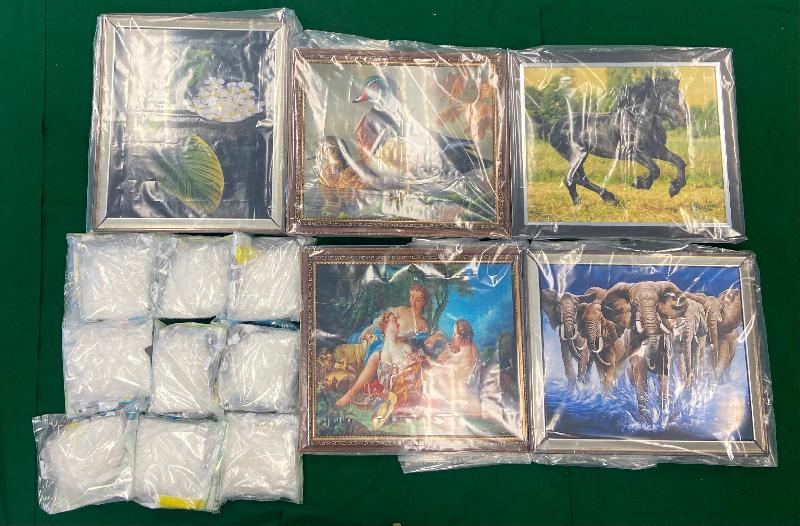 Hong Kong Customs seized about 9 kilograms of suspected methamphetamine and about 5 kilograms of suspected cocaine with a total estimated market value of about $12.2 million at the Kwai Chung Customhouse Cargo Examination Compound and Hong Kong International Airport respectively on May 20. Photo shows the suspected methamphetamine seized and the oil paintings used to conceal the dangerous drugs.