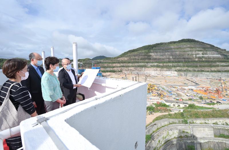 The Chief Executive, Mrs Carrie Lam (third left), today (June 10), accompanied by the Secretary for Transport and Housing, Mr Frank Chan Fan (second left), visited On Tai Estate at On Sau Road, Kwun Tong, which was located in a site which was formerly the Anderson Road Quarry. Photo shows Mrs Lam being briefed by a staff member of the Housing Department at the rooftop on the progress of various development plans of the site.
