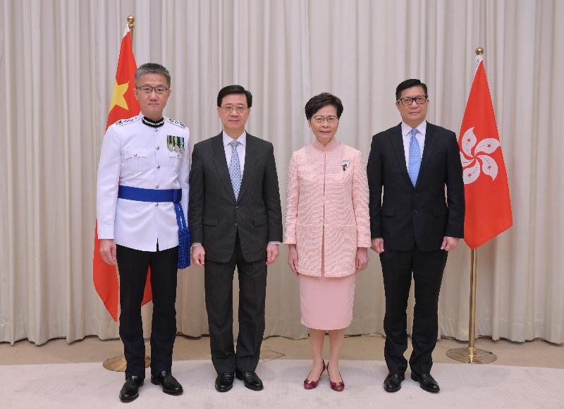 The Chief Executive, Mrs Carrie Lam (second right), is pictured with the new Chief Secretary for Administration, Mr John Lee Ka-chiu (second left); the new Secretary for Security, Mr Tang Ping-keung (first right); and the new Commissioner of Police, Mr Siu Chak-yee (first left), today (June 25).