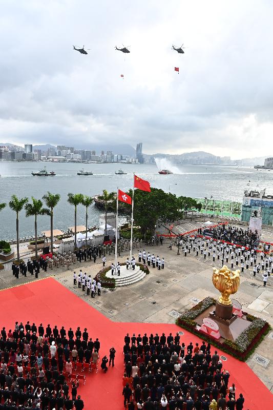 The disciplined services and the Government Flying Service perform a sea parade and a fly-past to mark the 24th anniversary of the establishment of the Hong Kong Special Administrative Region at the flag-raising ceremony at Golden Bauhinia Square in Wan Chai this morning (July 1).