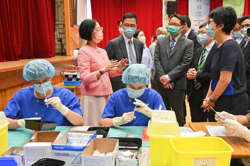 The Secretary for Food and Health, Professor Sophia Chan (back row, first left), and the Secretary for Education, Mr Kevin Yeung (back row, second left), today (July 2) visit Hong Kong Taoist Association Ching Chung Secondary School to inspect the operation of the outreach COVID-19 vaccination service at the school. 