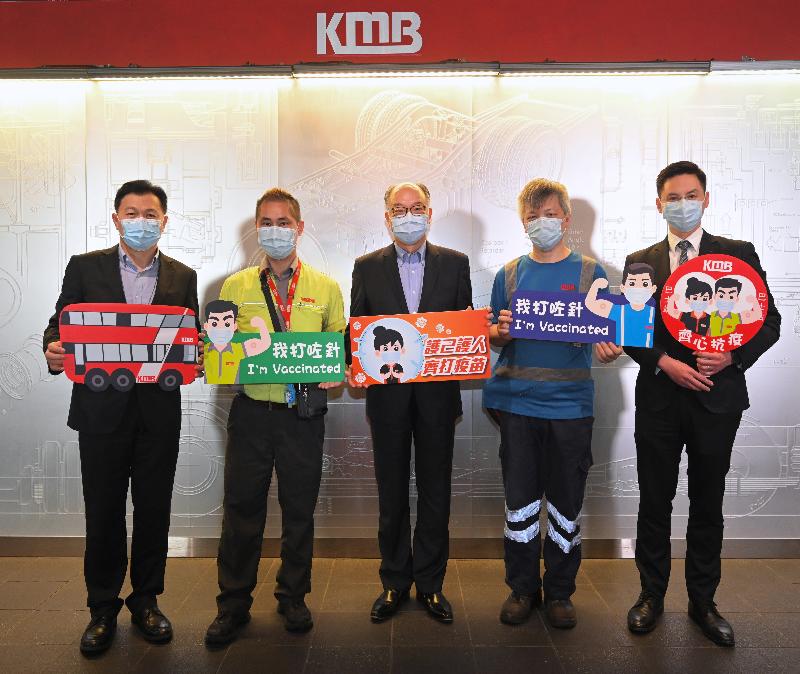The Secretary for Transport and Housing, Mr Frank Chan Fan, today (July 5) visited the staff of the Kowloon Motor Bus Company (1933) Limited (KMB) and their family members who received COVID-19 vaccination at KMB's Kowloon Bay Depot. Photo shows Mr Chan (centre); the KMB Administration Director, Mr Steve Hui (first left); Dr Chow Yat (first right) from the medical team of the Community Vaccination Centre at Osman Ramju Sadick Memorial Sports Centre, which provided the outreach service today; and staff members of KMB, showing their support for the COVID-19 Vaccination Programme.