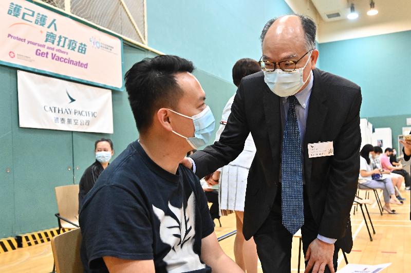 The Secretary for the Civil Service, Mr Patrick Nip, and the Secretary for Transport and Housing, Mr Frank Chan Fan, visited Cathay Pacific City today (July 19) to view the administering of the BioNTech vaccine to staff members of Cathay Pacific, as arranged by the Government's outreach vaccination service. Photo shows Mr Chan (right) chatting with a staff member of Cathay Pacific (left) who was vaccinated. 