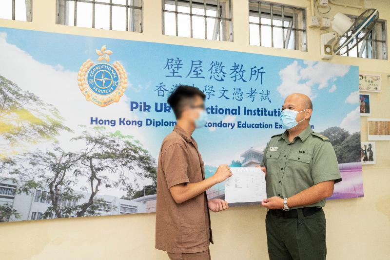 Seven young persons in custody enrolled in the HKDSE Examination this year. Photo shows the Superintendent of Pik Uk Correctional Institution, Mr Chu Yuen-ming (right), presenting an examination certificate to a young person in custody.