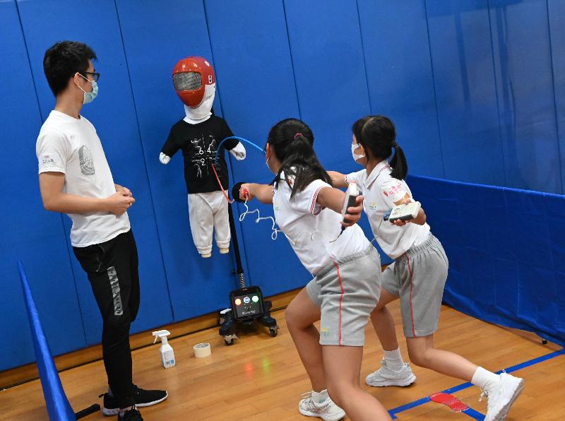 "Launching of Olympics Live Zone in support of Tokyo 2020 Olympics" ceremony was held at the Kowloon Park Sports Centre today (July 23). Picture shows some members of the public attending the launch-out event join fencing play-in session.