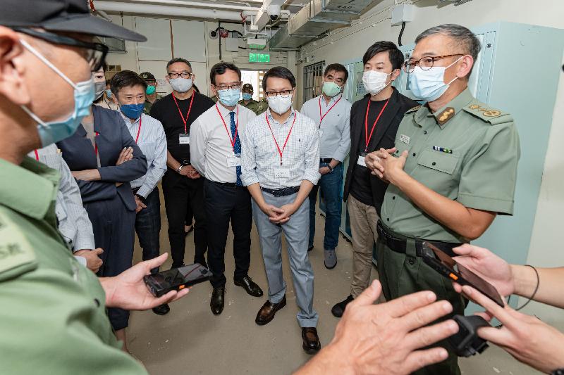 The Legislative Council Panel on Security visits the Tai Tam Gap Correctional Institution to better understand the operation and future development of "Smart Prison". Photo shows Members of the Legislative Council, accompanied by the Commissioner of Correctional Services, Mr Woo Ying-ming (first right), being briefed on the Staff Handheld Device with data access and message delivery functions.