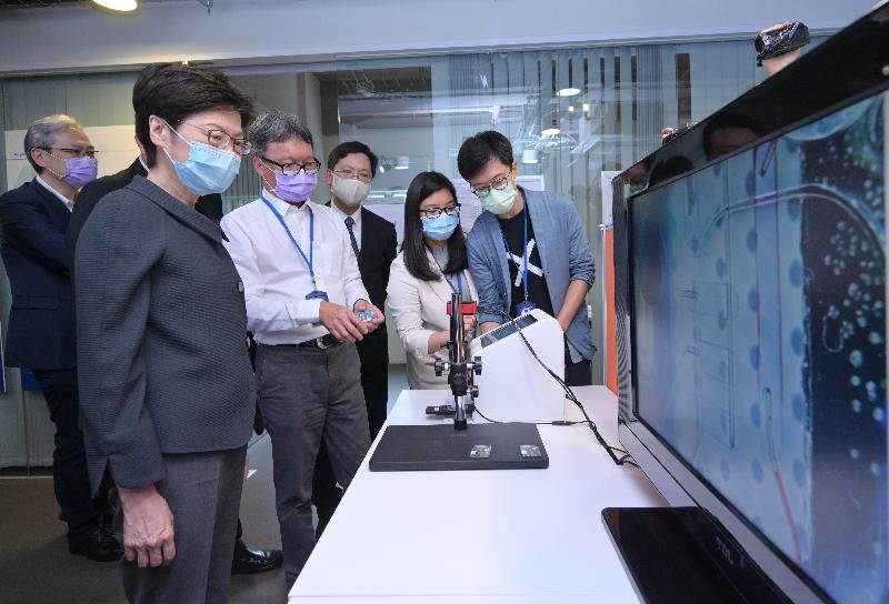 The Chief Executive, Mrs Carrie Lam, today (July 29) visited a local biotech company in Fo Tan. Photo shows Mrs Lam (second left), accompanied by the Secretary for Innovation and Technology, Mr Alfred Sit (third right), receiving a briefing from a representative of the company on a portable testing instrument it developed.