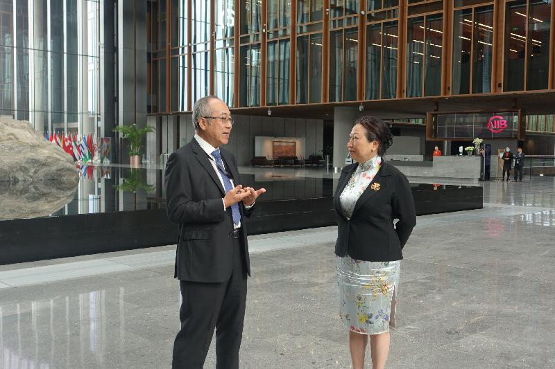 The Secretary for Justice, Ms Teresa Cheng, SC, visited the Asian Infrastructure Investment Bank (AIIB) in Beijing this morning (July 30). Photo shows Ms Cheng (right) being briefed by the Director General of the AIIB's Human Resources Department, Mr Tse Man-shing (left), on the AIIB.