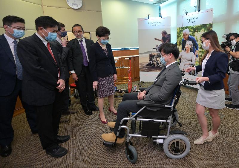The Chief Executive, Mrs Carrie Lam, today (July 30) visited Lingnan University (LU). Photo shows Mrs Lam (fifth left), accompanied by the LU President, Professor Leonard Cheng (second left), receiving a briefing on a wheelchair handle sensoring system developed under the Lingnan Entrepreneurship Initiative.