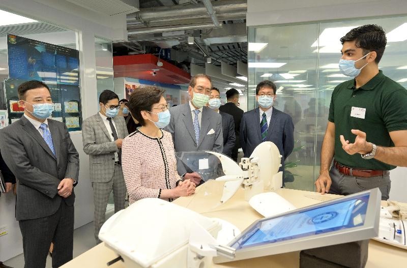 The Chief Executive, Mrs Carrie Lam, today (August 2) visited the University of Hong Kong (HKU). Photo shows Mrs Lam (third left), accompanied by the Council Chairman of HKU, Professor Arthur Li (fourth left), and the President and Vice-Chancellor of HKU, Professor Zhang Xiang (first left), receiving a briefing from a student on a robotic fish developed by an HKU research team.