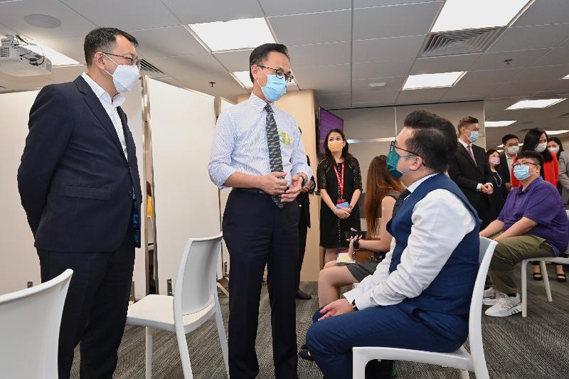 The Secretary for the Civil Service, Mr Patrick Nip, viewed the administering of a COVID-19 vaccine by the Government's outreach vaccination service at AIA Hong Kong and Macau today (August 3). Photo shows Mr Nip (second left) and the General Manager, Agency Distribution of AIA Hong Kong and Macau, Mr Jim Jan-zen (first left), chatting with a person who is about to receive his vaccination.