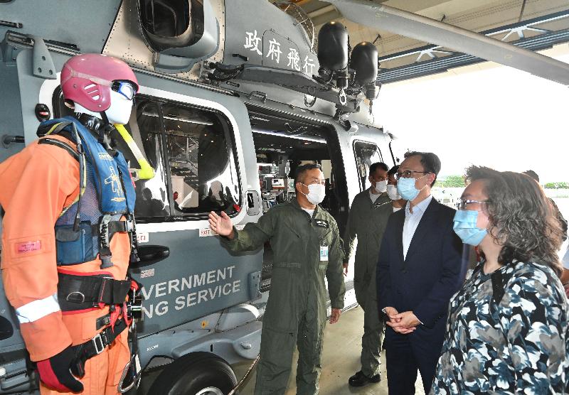 The Secretary for the Civil Service, Mr Patrick Nip, visited the Government Flying Service today (August 18). Photo shows Mr Nip (second right) being briefed on the work of air search and rescue. Looking on is the Permanent Secretary for the Civil Service, Mrs Ingrid Yeung (first right).