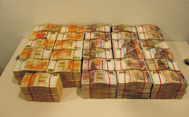Hong Kong Customs mounted an operation codenamed "Interceptor" this month and successfully detected a suspected money laundering case involving about $170 million while five men were arrested. This is the first time Customs has detected a money laundering case of cross-boundary vehicle drivers assisting in money laundering activities. Photo shows the cash amounting to about $20 million seized by Customs officers when they intercepted two cross-boundary vehicles driven by two of the cross-boundary vehicle drivers.