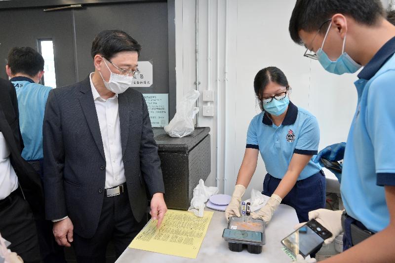 The Chief Secretary for Administration, Mr John Lee, visited Penny's Bay Quarantine Centre on Lantau Island this afternoon (September 7) to view the preparatory work for opening some of the quarantine units at the centre for foreign domestic helpers arriving in Hong Kong. Photo shows Mr Lee (left) learning about the arrangements for meals.