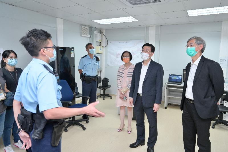 The Chief Secretary for Administration, Mr John Lee, visited Penny's Bay Quarantine Centre on Lantau Island this afternoon (September 7) to view the preparatory work for opening some of the quarantine units at the centre for foreign domestic helpers arriving in Hong Kong. Photo shows Mr Lee (second right) chatting with colleagues from the Hong Kong Police Force to learn about their work in operating the quarantine centre. Looking on are the Secretary for Labour and Welfare, Dr Law Chi-kwong (first right), and the Secretary for Food and Health, Professor Sophia Chan (third right).