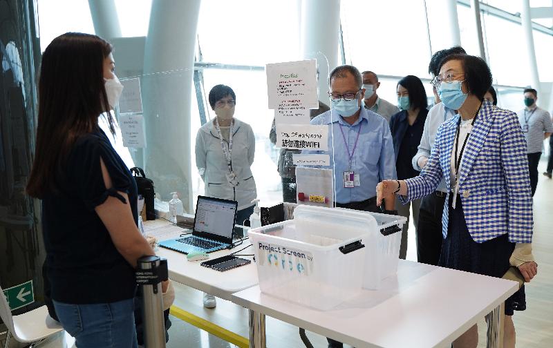 The Secretary for Food and Health, Professor Sophia Chan, visited Hong Kong International Airport this afternoon (September 13), and inspected various passenger and cargo traffic measures for reducing the risk of importing COVID-19 into the community. Photo shows Professor Chan (first right) inspecting the workflow of the "test-and-hold" procedures for inbound travellers under the Return2HK Scheme at the Temporary Specimen Collection Centre in the restricted area of the Airport.