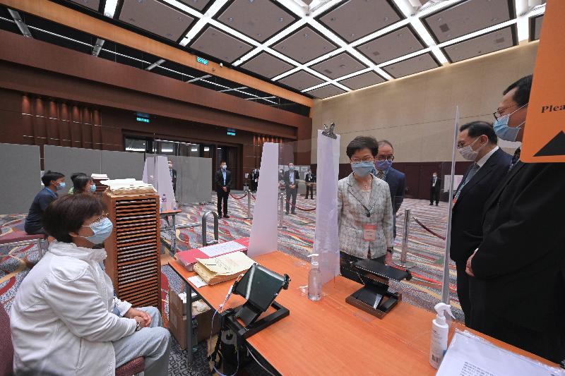 The Chief Executive, Mrs Carrie Lam, visited the polling station at the Hong Kong Convention and Exhibition Centre this morning (September 19) to inspect the operation of the polling station of the 2021 Election Committee Subsector Ordinary Elections. Photo shows Mrs Lam (fourth right), accompanied by the Secretary for Constitutional and Mainland Affairs, Mr Erick Tsang Kwok-wai (third right), briefed by the Chairman of the Electoral Affairs Commission, Mr Justice Barnabas Fung Wah (second right) and the staff on the operation. 