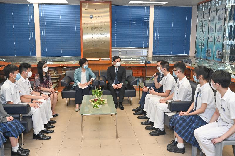 The Chief Secretary for Administration, Mr John Lee, today (October 4) visited Clementi Secondary School. Photo shows Mr Lee (centre), accompanied by the Under Secretary for Education, Dr Choi Yuk-lin (fourth left), and the Principal of Clementi Secondary School, Mrs Bonnie Fung (third left), listening to students talk about their experience and thoughts about participating in National Day celebration activities and other civic education-related learning activities.