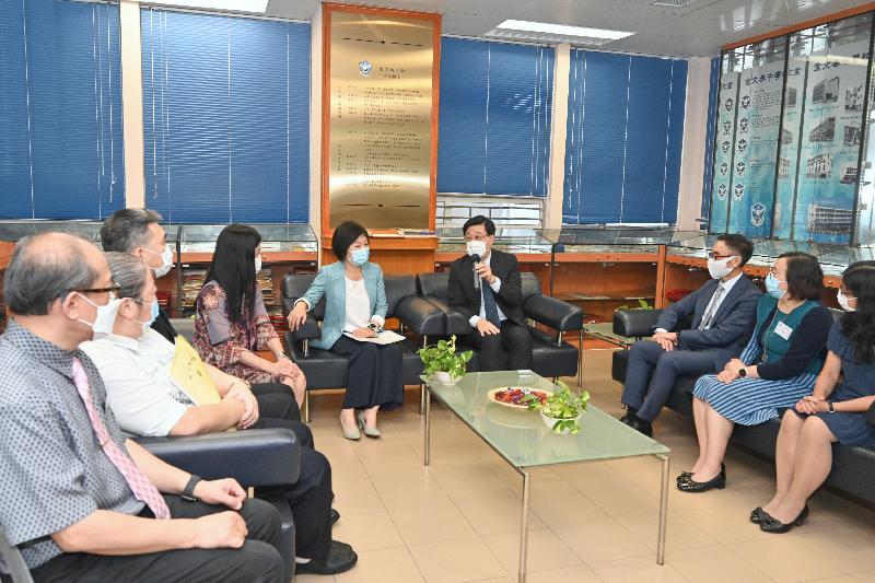 The Chief Secretary for Administration, Mr John Lee, today (October 4) visited Clementi Secondary School. Photo shows Mr Lee (fourth right), accompanied by the Under Secretary for Education, Dr Choi Yuk-lin (fifth right), and the Principal of Clementi Secondary School, Mrs Bonnie Fung (fourth left), chatting with teachers to understand their progress in promoting national security education inside and outside the classroom.