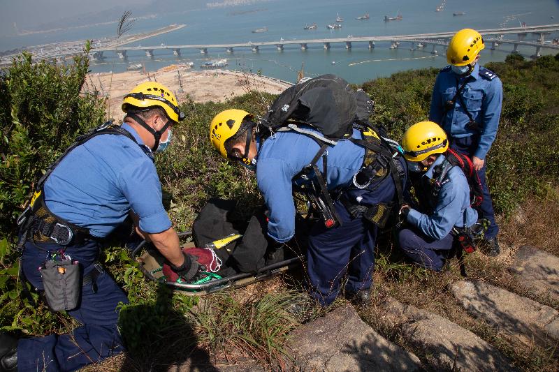 Fire Services personnel simulate the rescue of an injured person during an inter-departmental vegetation fire and mountain rescue operation exercise today (November 25).