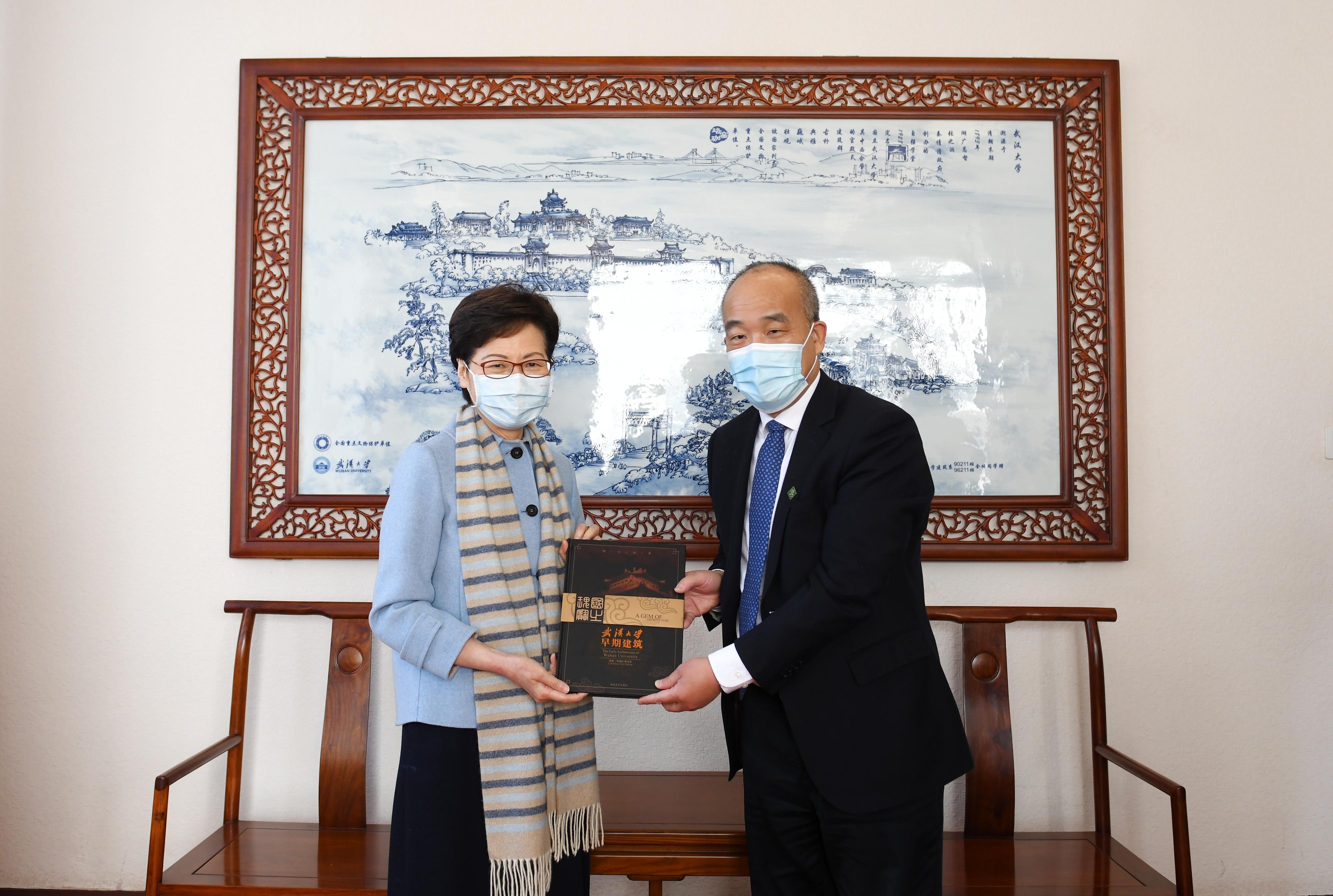 The Chief Executive, Mrs Carrie Lam, visited Wuhan University in Wuhan today (December 1). Photo shows Mrs Lam (left) receiving a souvenir from the President of Wuhan University, Professor Dou Xiankang (right).