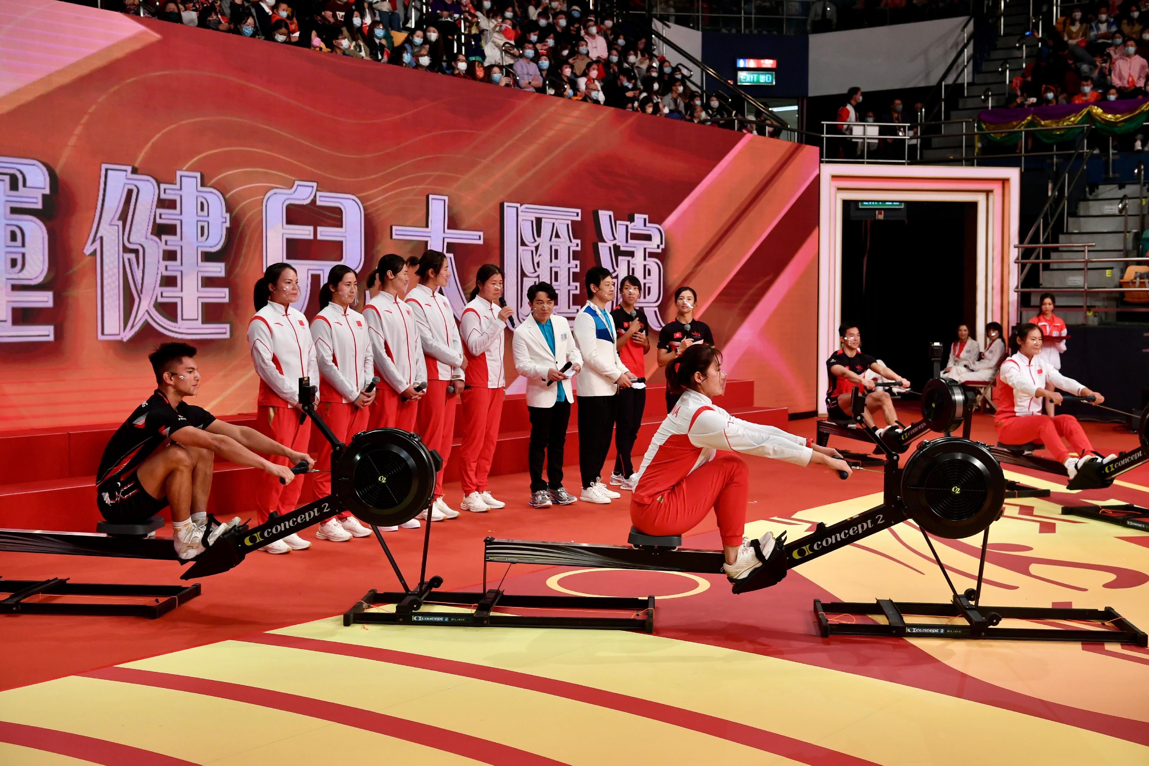 The delegation of Tokyo 2020 Olympic Games Mainland Olympians attended the "Mainland Olympians Variety Show" at Queen Elizabeth Stadium in Wan Chai this afternoon (December 4). Photo shows the Mainland rowing athletes and Hong Kong athletes taking part in a rowing contest.