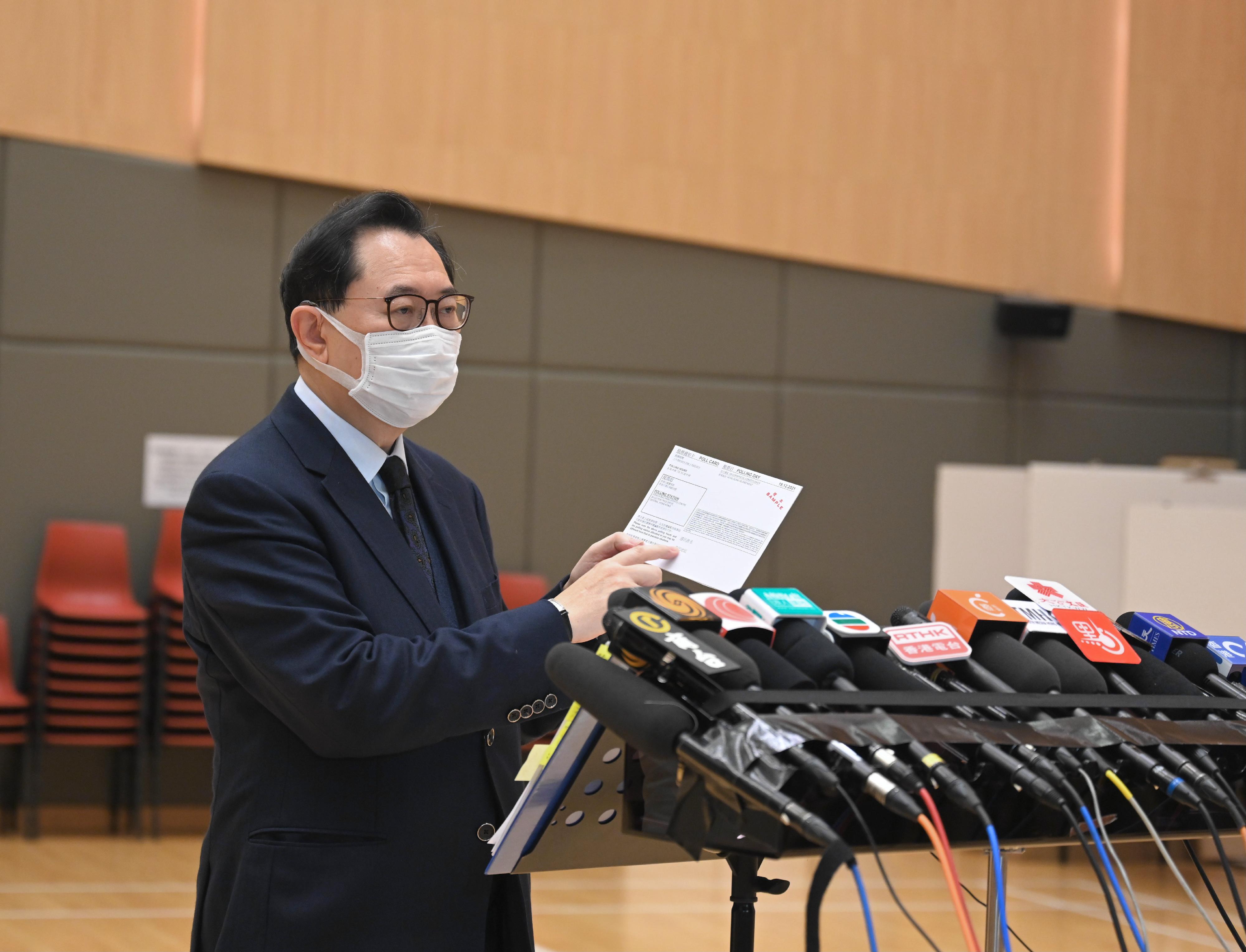The Chairman of the Electoral Affairs Commission, Mr Justice Barnabas Fung Wah, demonstrated the proper procedure to cast votes in the Legislative Council General Election during his visit to a mock polling station at the North Point Community Hall today (December 14). Photo shows Mr Justice Fung meeting the media after the visit.