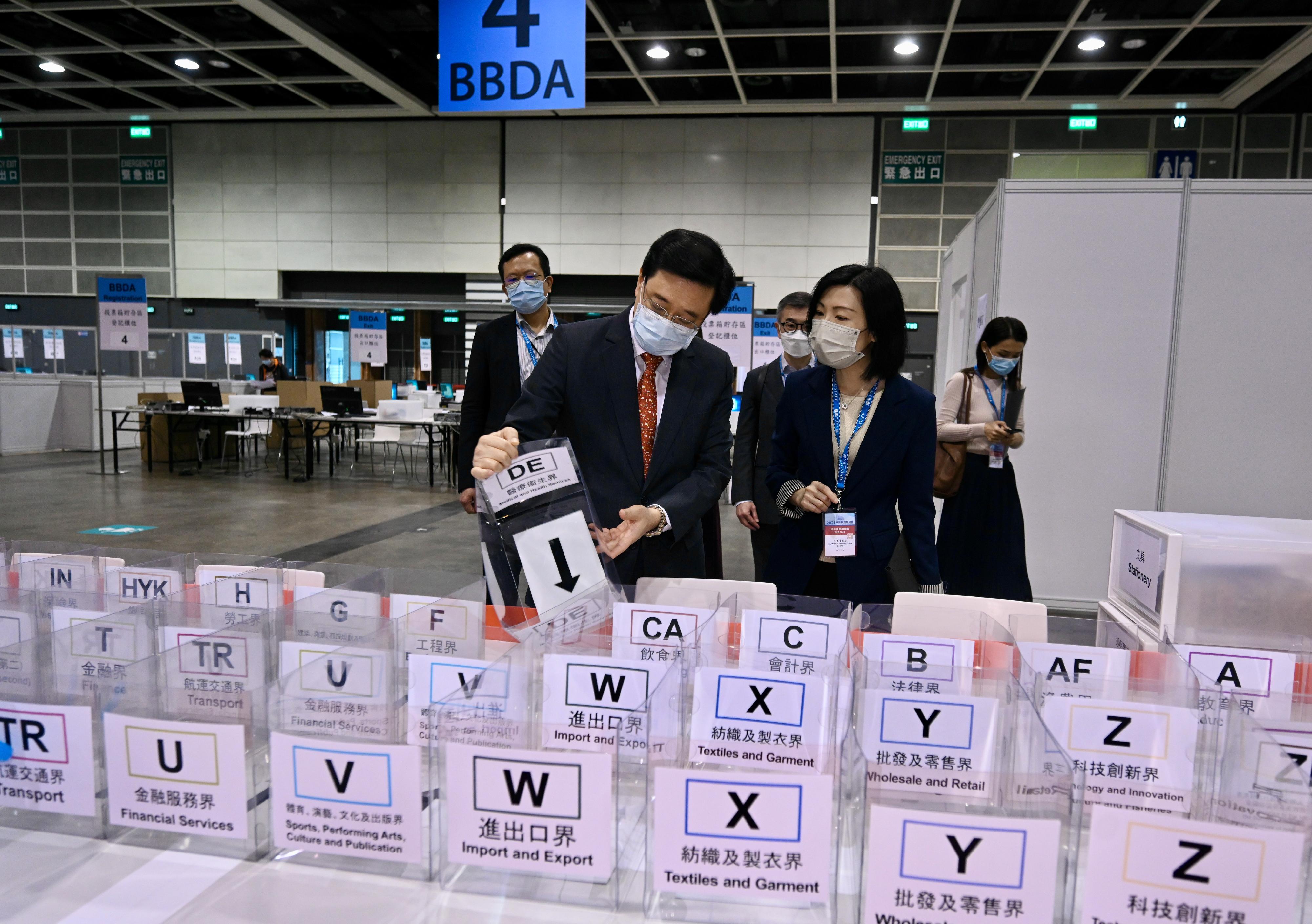 The Chief Secretary for Administration, Mr John Lee, visited the Hong Kong Convention and Exhibition Centre today (December 17) to inspect the preparatory work progress of the central counting station for the Legislative Council General Election. Photo shows Mr Lee (left) being briefed by a staff member on the preparations for the counting procedures.