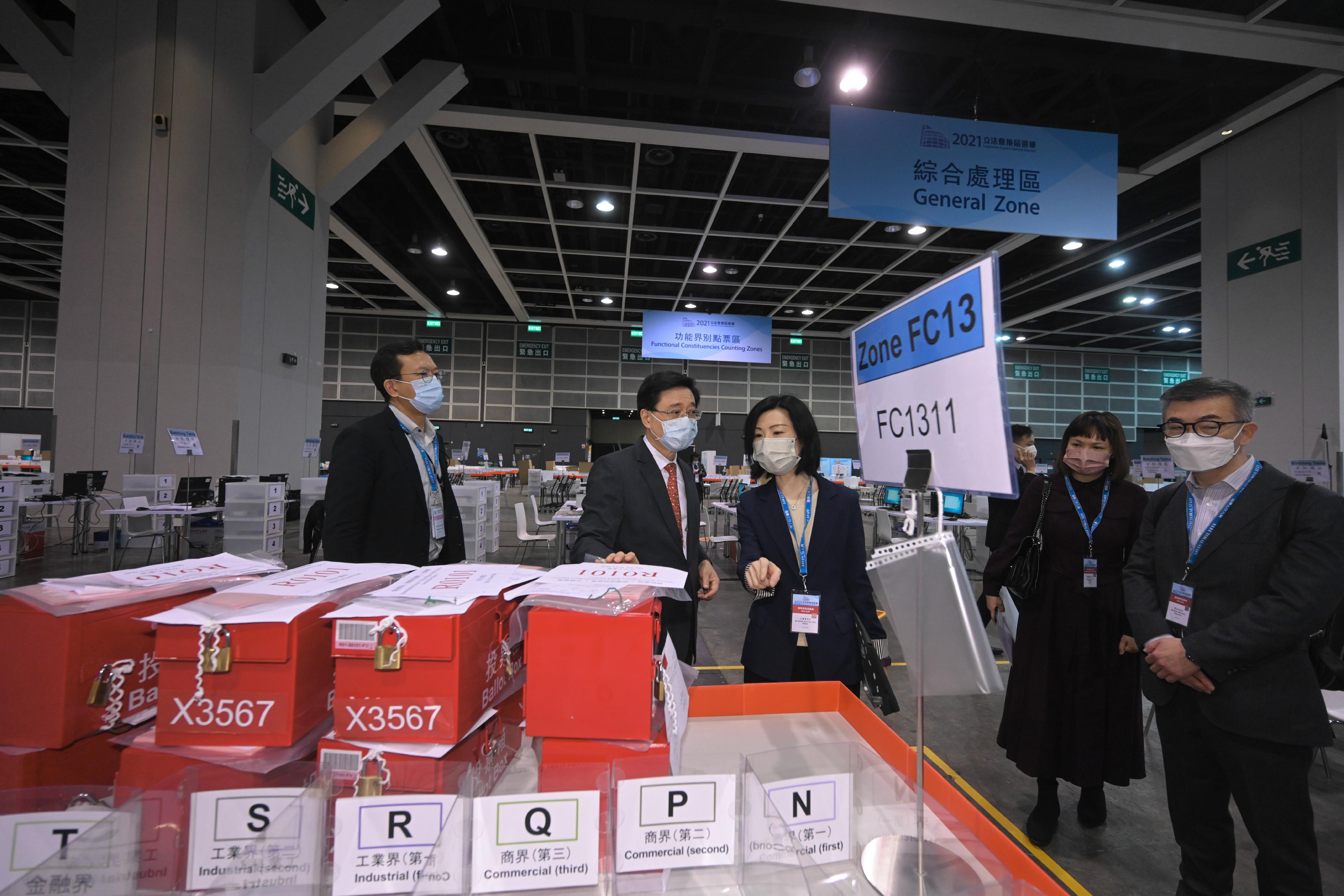 The Chief Secretary for Administration, Mr John Lee, visited the Hong Kong Convention and Exhibition Centre today (December 17) to inspect the preparatory work progress of the central counting station for the Legislative Council General Election. Photo shows Mr Lee (second left) being briefed by a staff member on the preparations for the counting procedures.