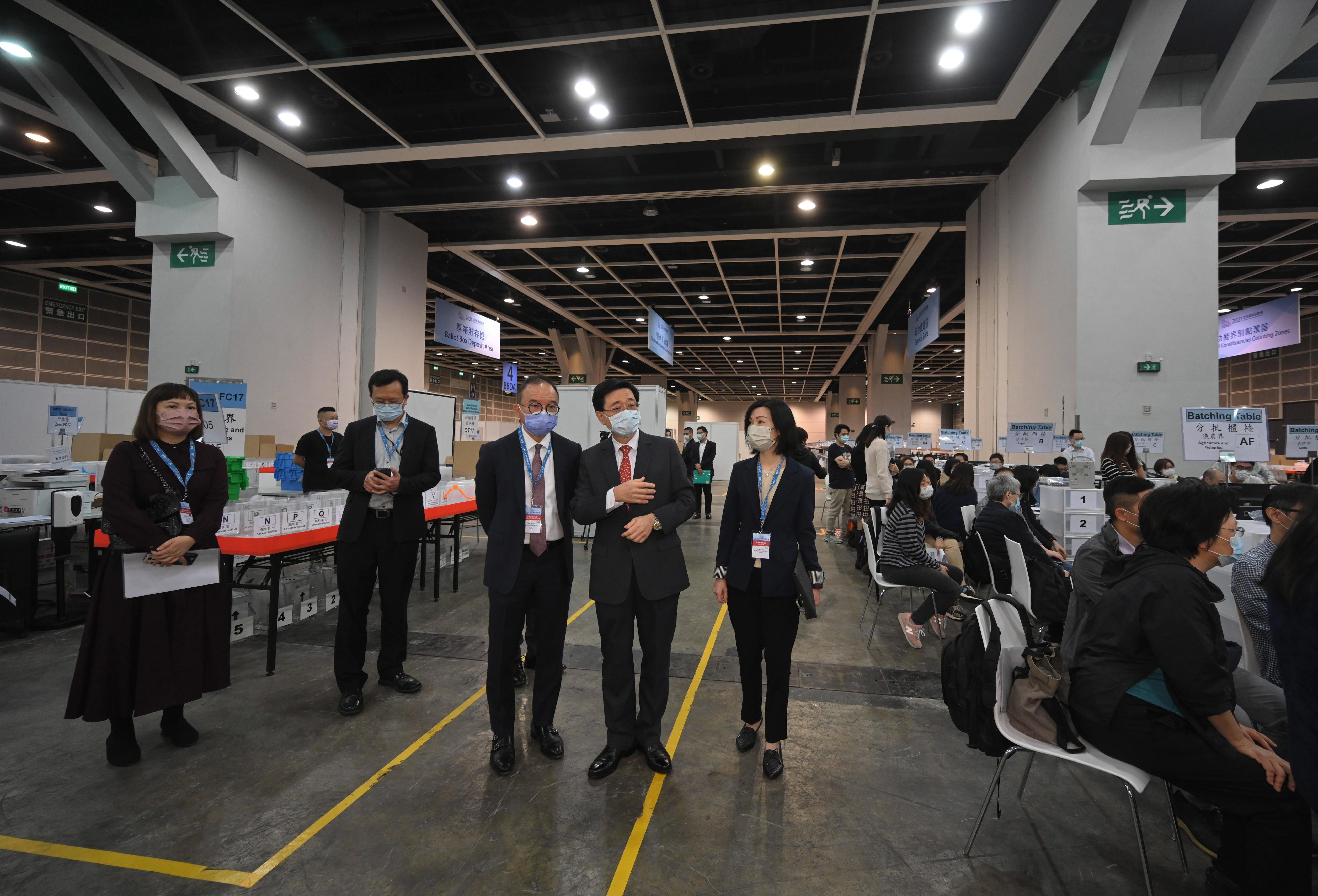 The Chief Secretary for Administration, Mr John Lee, visited the Hong Kong Convention and Exhibition Centre today (December 17) to inspect the preparatory work progress of the central counting station for the Legislative Council General Election. Photo shows Mr Lee (second right) and the Secretary for Constitutional and Mainland Affairs, Mr Erick Tsang Kwok-wai (third right), inspecting the practical sessions and simulated activities on-site.