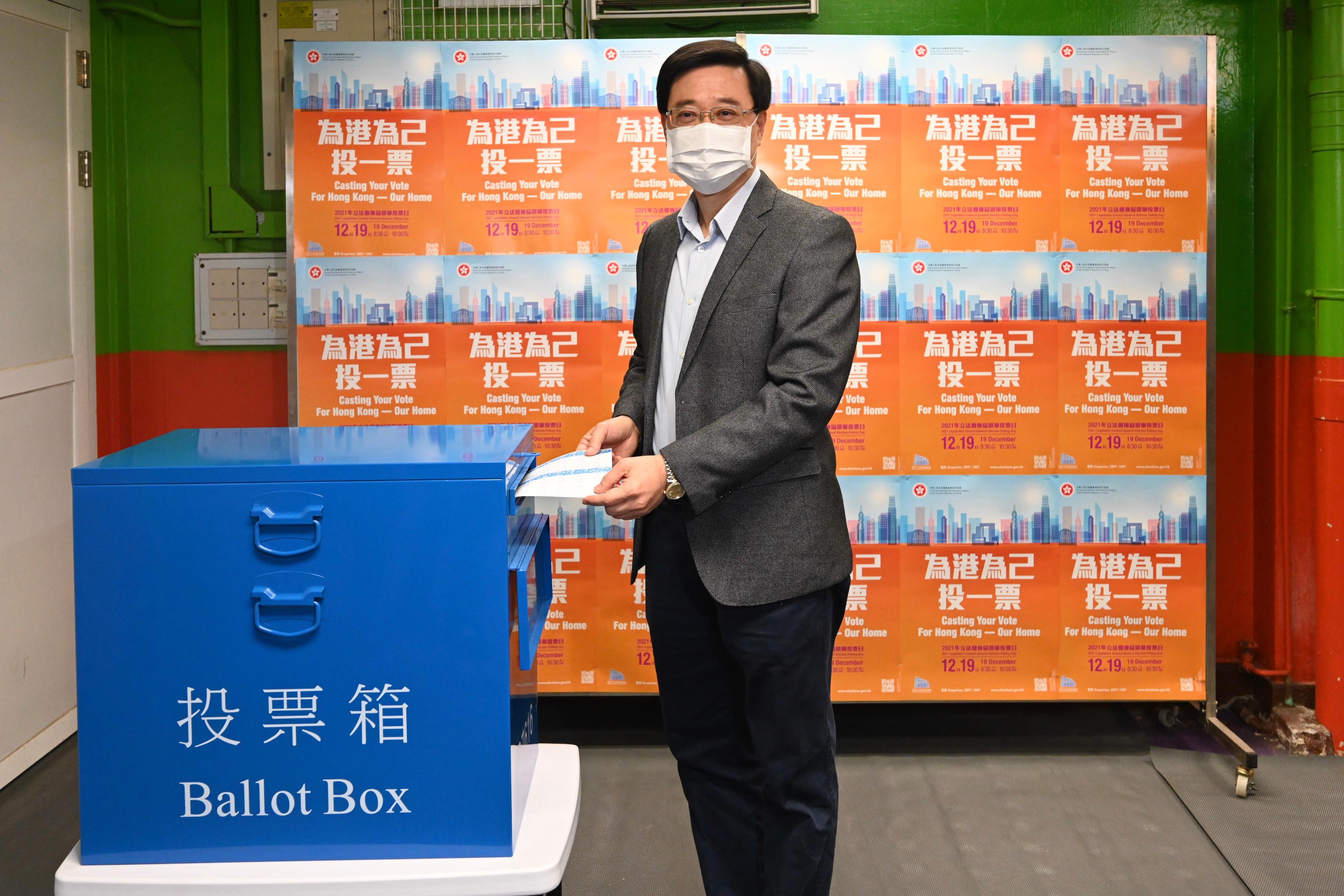 The Chief Secretary for Administration, Mr John Lee, casts his vote in the 2021 Legislative Council General Election at Yaumati Kaifong Association School this morning (December 19).